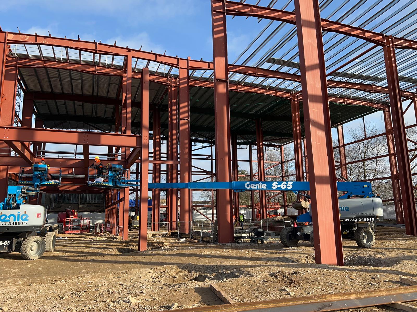 Structural steel frame against blue sky on building site